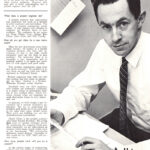 Black and white portrait of a man working at a desk with documents.