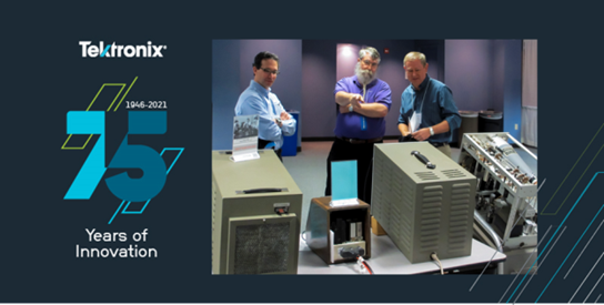 Three people examining vintage Tektronix equipment